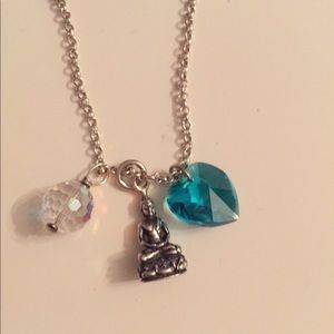 Silver chain with buda and crystal charms.